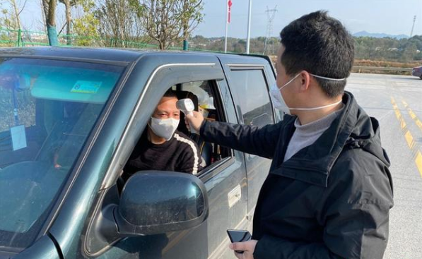 工作人員正為進出人員測量體溫